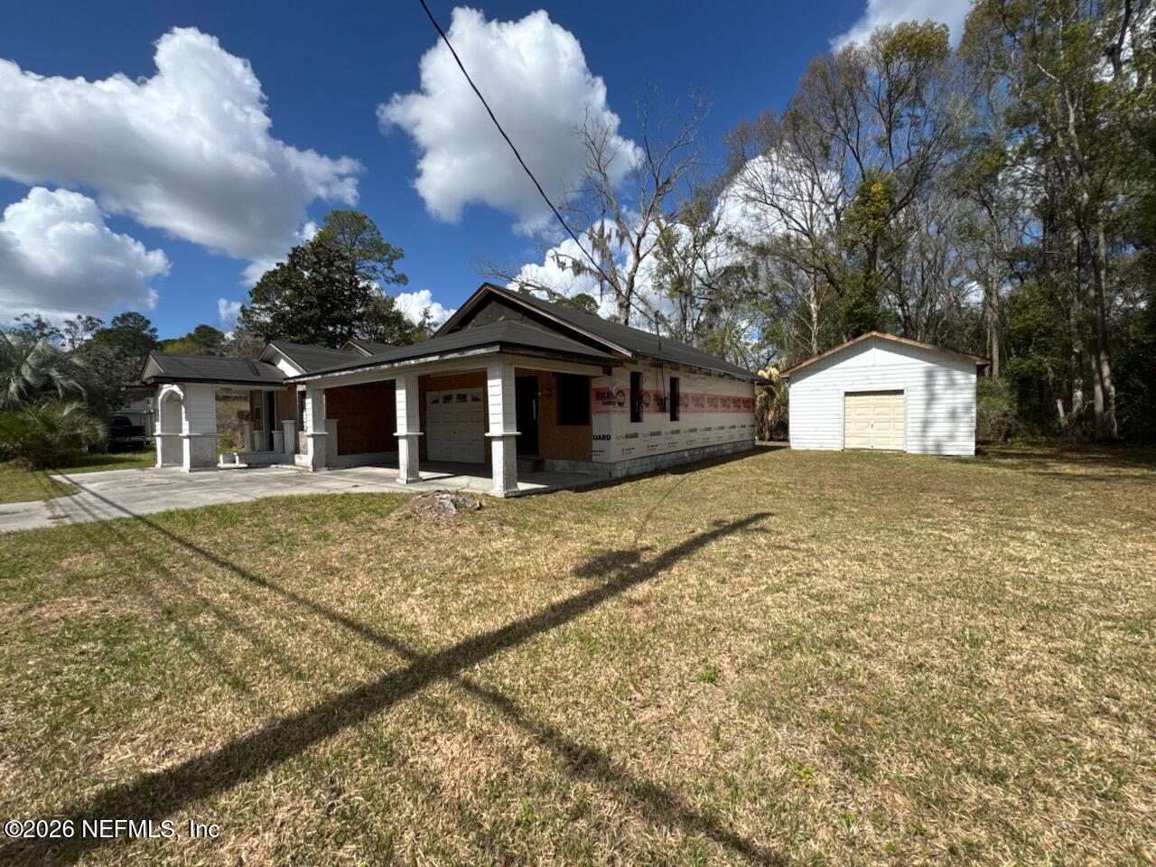 541 Highway 90 Baldwin, FL 32234 - Photo 5 of 14 a front view of a house with a yard and garage