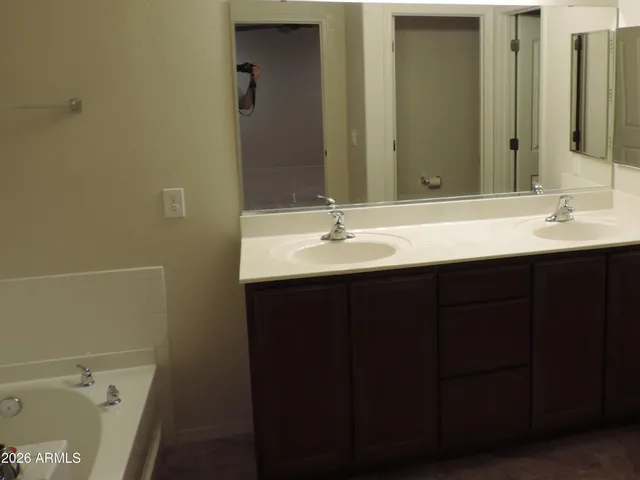 a bathroom with a double vanity sink and a mirror