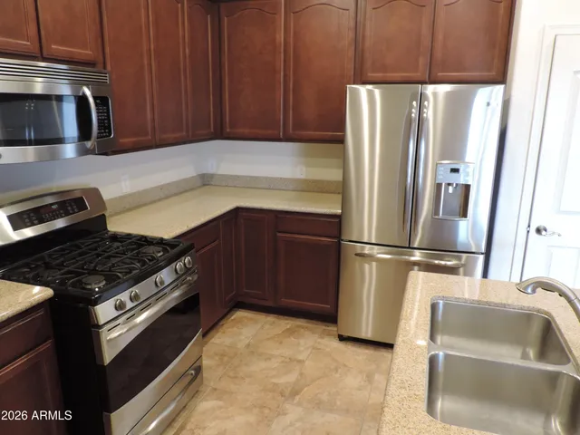 a kitchen with a refrigerator stove and microwave