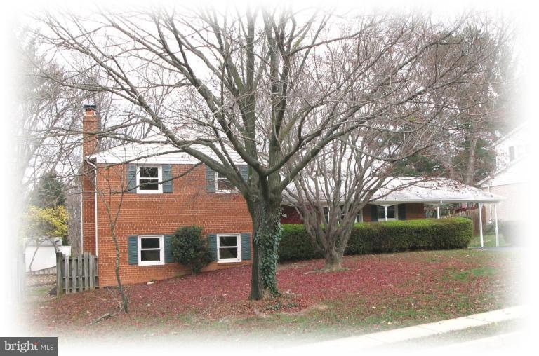 6807 Sydenstricker Road Springfield, VA 22152 - Photo 1 of 7 a front view of a house with yard and green space