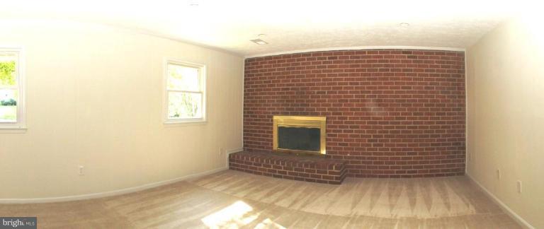 6807 Sydenstricker Road Springfield, VA 22152 - Photo 3 of 7 a view of empty room with a fireplace
