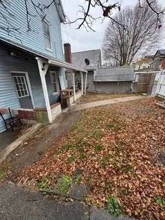 a view of a brick house with wooden fence