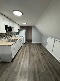 a view of a kitchen with a sink and a stove top oven