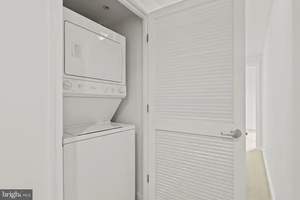 a kitchen that has a sink and a stove with wooden floor