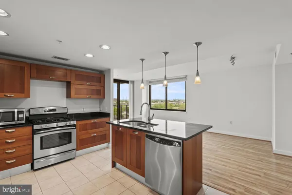 a kitchen with granite countertop cabinets stainless steel appliances and a sink