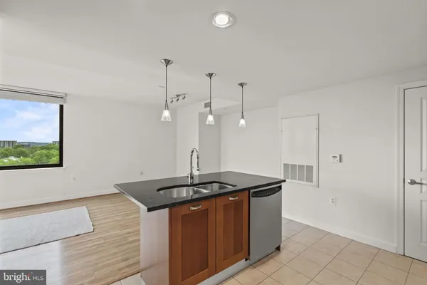 a kitchen with stainless steel appliances granite countertop a sink a counter space and cabinets