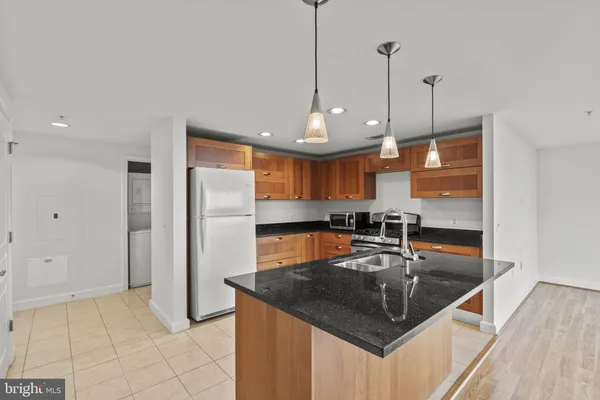 a view of kitchen with stainless steel appliances kitchen island wooden floor and window