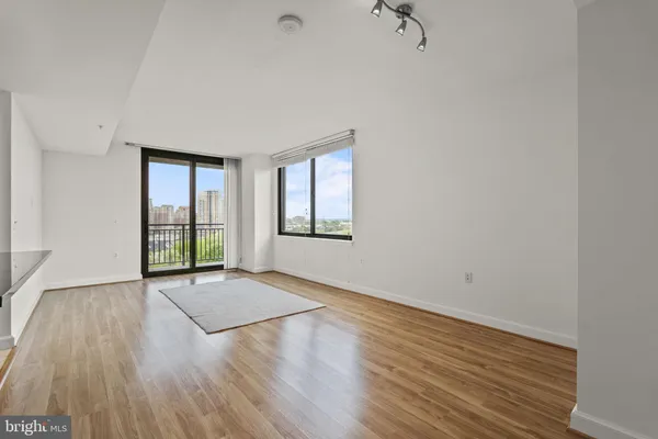 a view of empty room with wooden floor