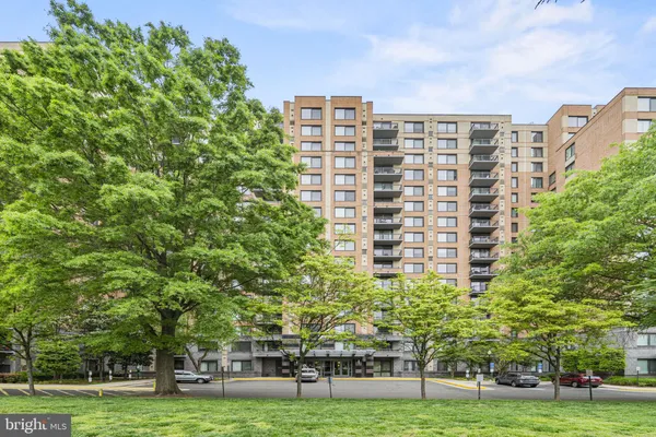 a view of a building with garden and trees