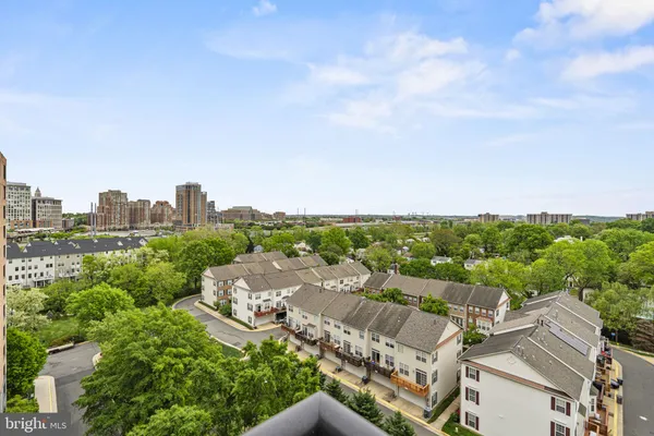 a living room with furniture large windows and a chandelier