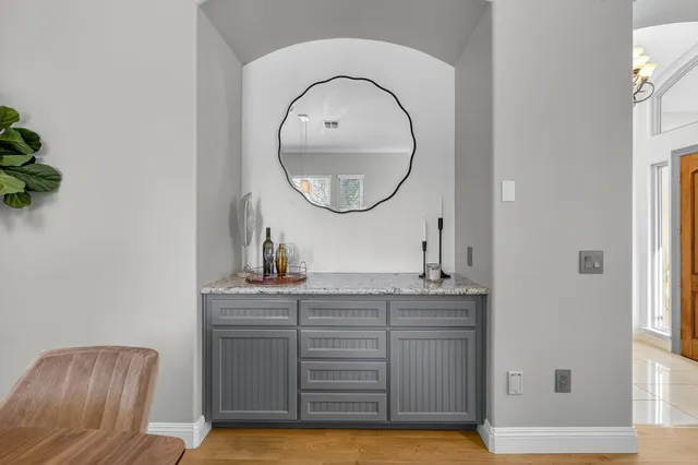 a kitchen with white cabinets and refrigerator