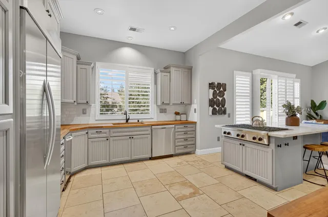 a kitchen with a stove top oven and cabinets