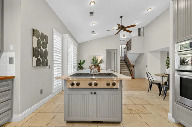 a view of a hallway with entryway and hall with wooden floor