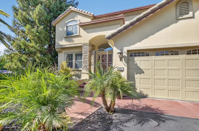 a view of a patio with table and chairs and potted plants