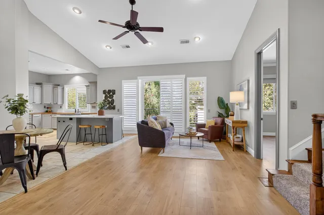 a white bed sitting in a bedroom next to a window