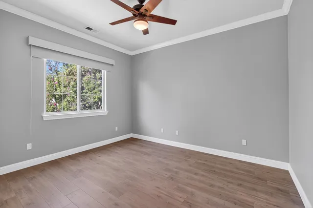 a large white kitchen with a sink and dishwasher a stove with wooden floor