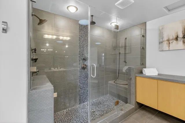 a bathroom with a shower and a bath tub