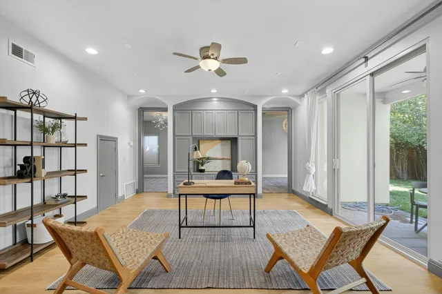 a view of a house with brick walls and a yard with plants