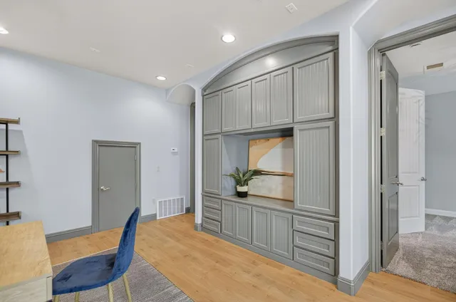 a view of a backyard with plants and large trees