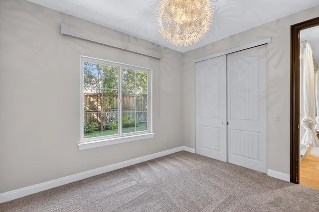 an aerial view of a house with garden space and lake view