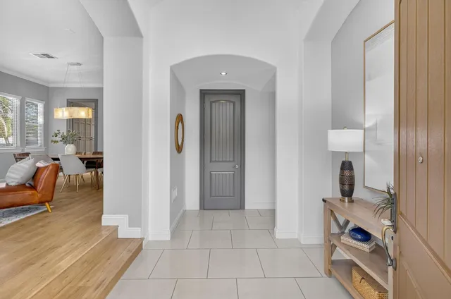 a spacious bedroom with a bed and a potted plant