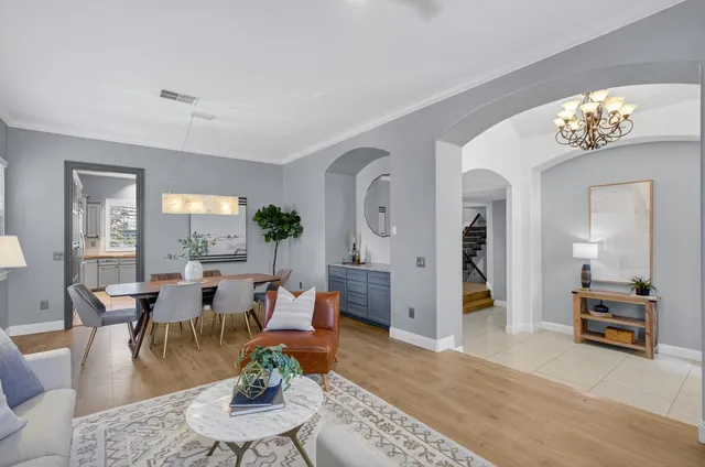 a view of a dining room with furniture and chandelier