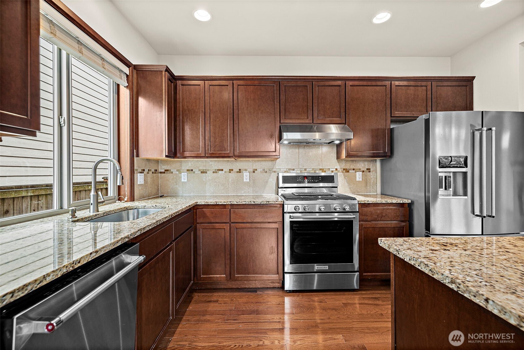 4708 167th Street Southwest Edmonds, WA 98026 - Photo 6 of 23 a kitchen with stainless steel appliances granite countertop a stove a refrigerator and a sink