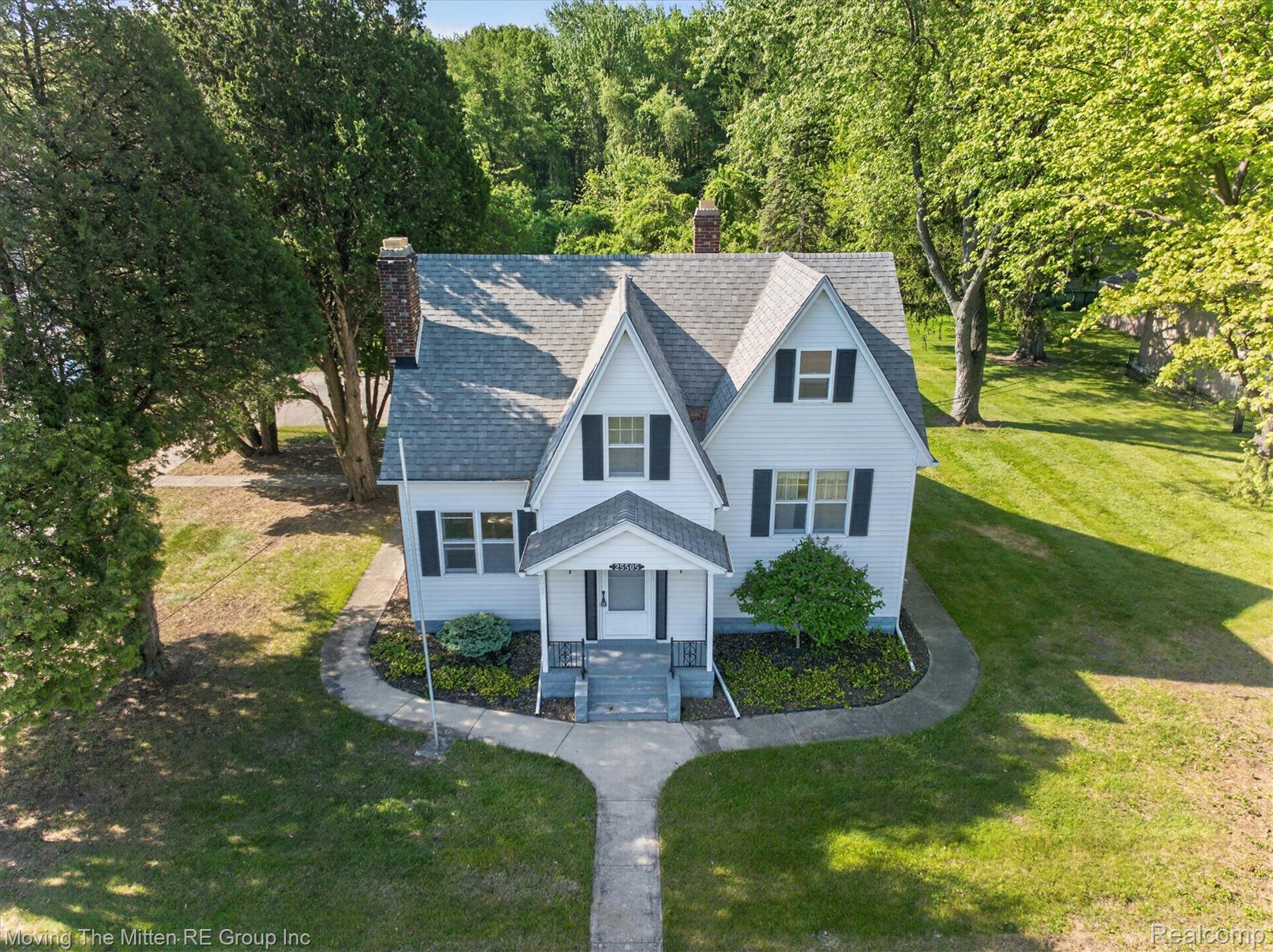 25505 Wick Road Taylor, MI 48180 - Photo 52 of 68 View of front facade featuring a chimney, a front lawn, and a shingled roof