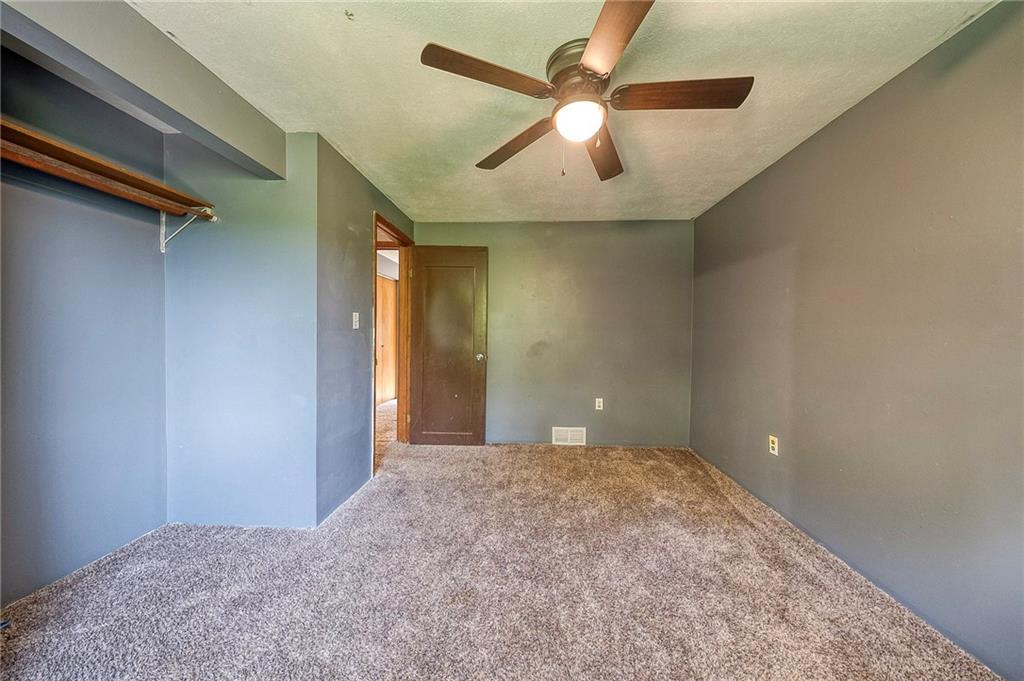 210 Swiontek Road Aliquippa, PA 15001 - Photo 11 of 28 a view of a big room with wooden floor and a ceiling fan