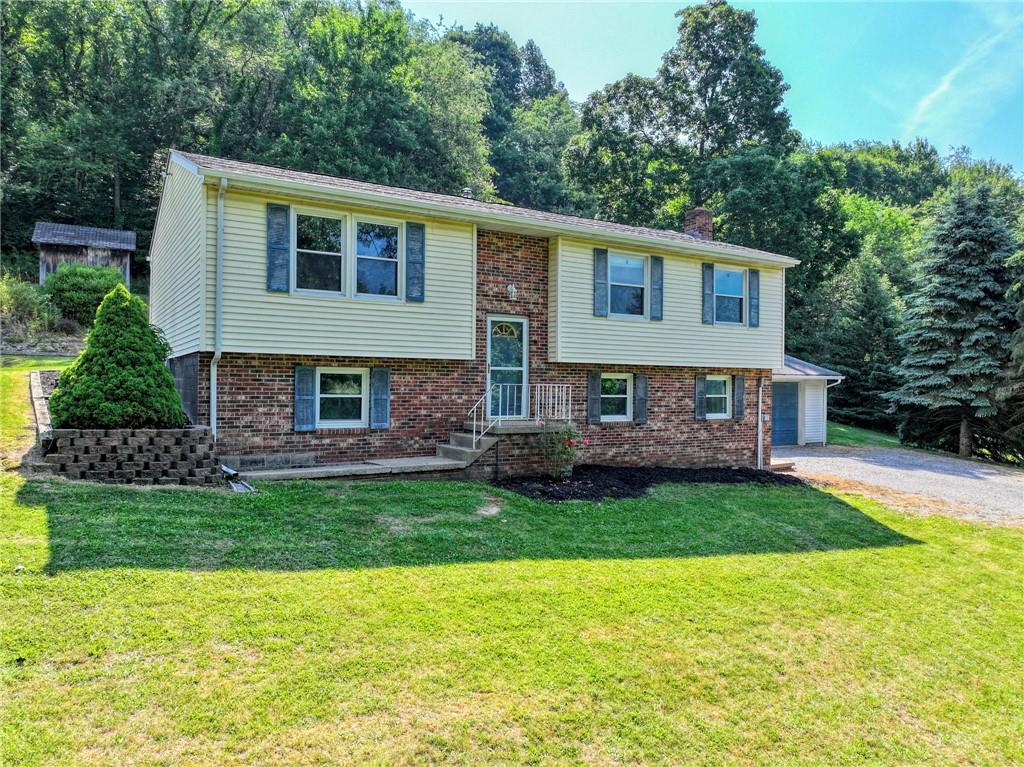 210 Swiontek Road Aliquippa, PA 15001 - Photo 2 of 28 a front view of a house with a garden