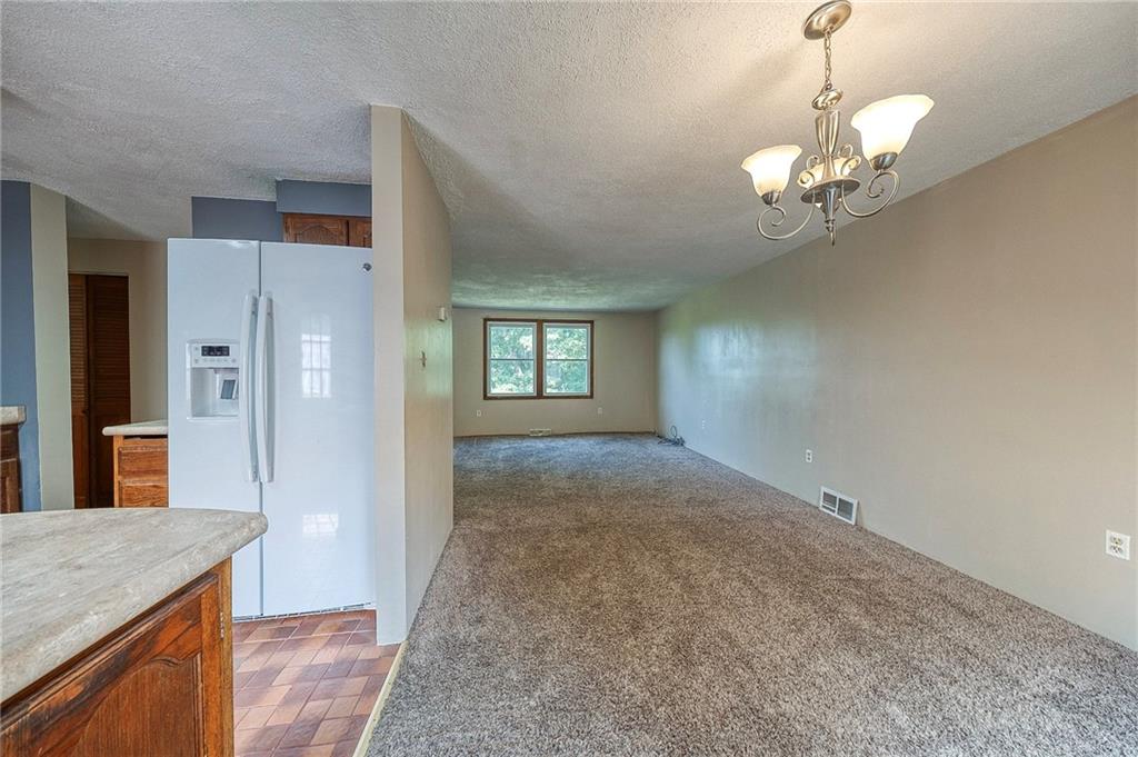 210 Swiontek Road Aliquippa, PA 15001 - Photo 4 of 28 a view of a hallway with wooden floor and a kitchen