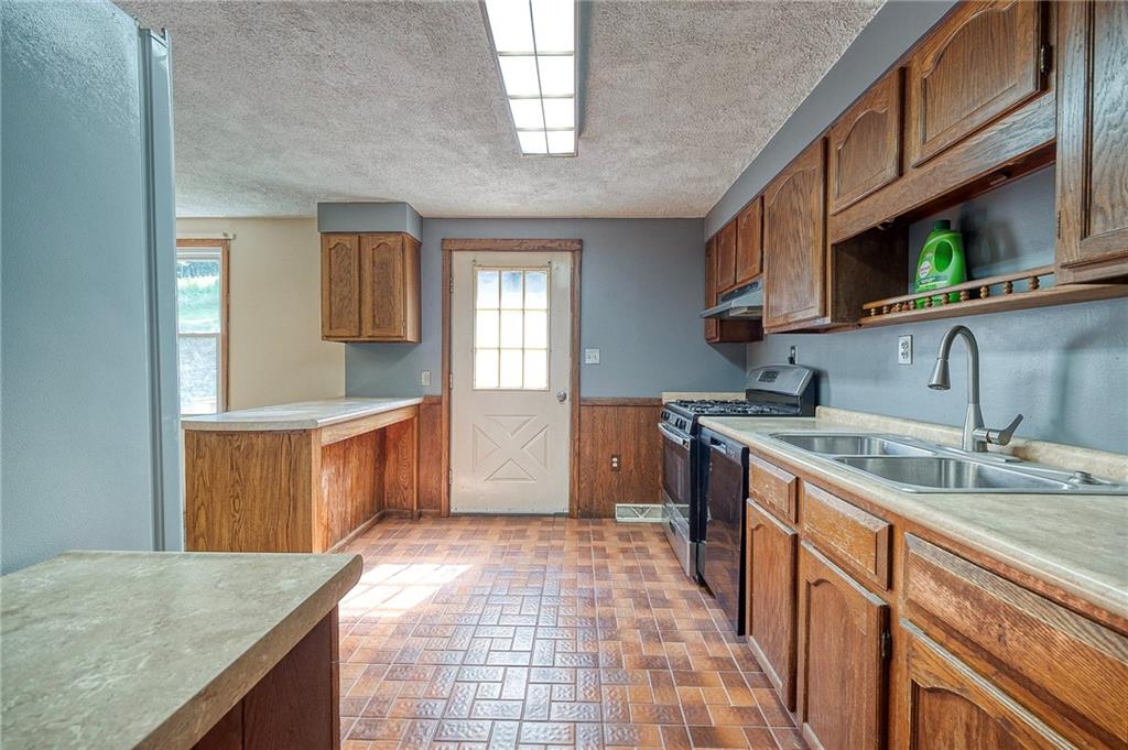 210 Swiontek Road Aliquippa, PA 15001 - Photo 6 of 28 a kitchen with stainless steel appliances granite countertop a sink stove and cabinets