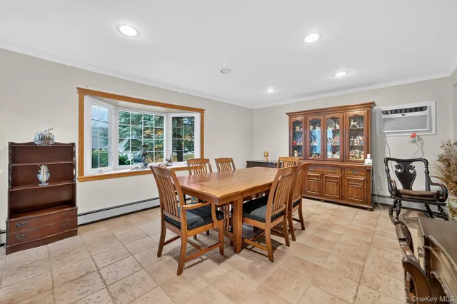 a dining room with furniture and a floor to ceiling window