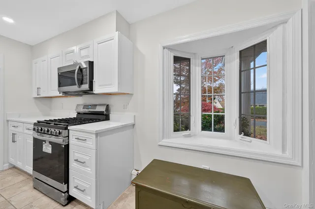 a kitchen with a stove microwave and sink