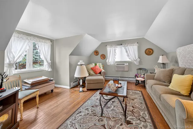a living room with furniture fireplace and a window