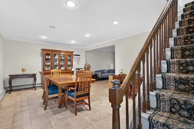 a dining room with furniture and entryway