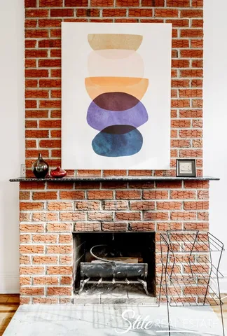 a living room with furniture a fireplace and a table