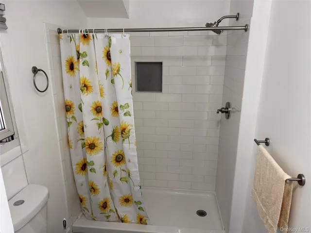 a bathroom that has a glass shower door