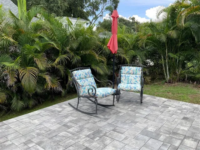 a view of a chairs and table in backyard of the house
