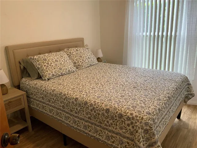 a bed sitting in a bedroom next to a window