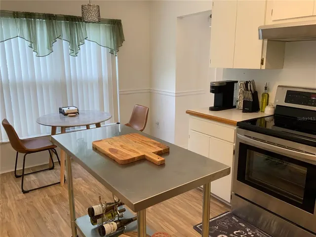 a kitchen with a table chairs and a stove