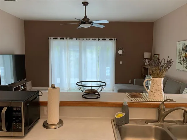 a living room with a couch and a chandelier