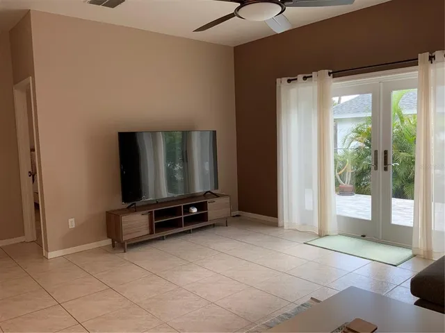 a living room with furniture gym equipment and a large window