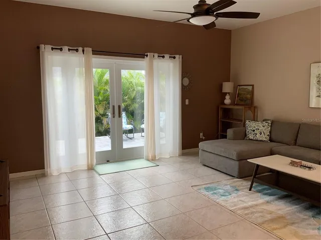 a living room with furniture and a floor to ceiling window