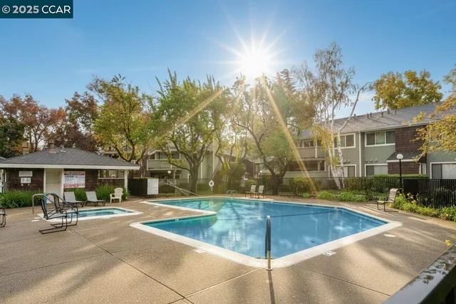 a view of a house with swimming pool and sitting area