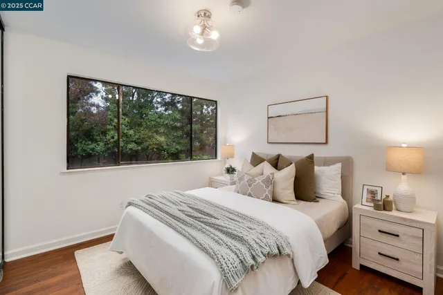 a bedroom with a bed and a mirror