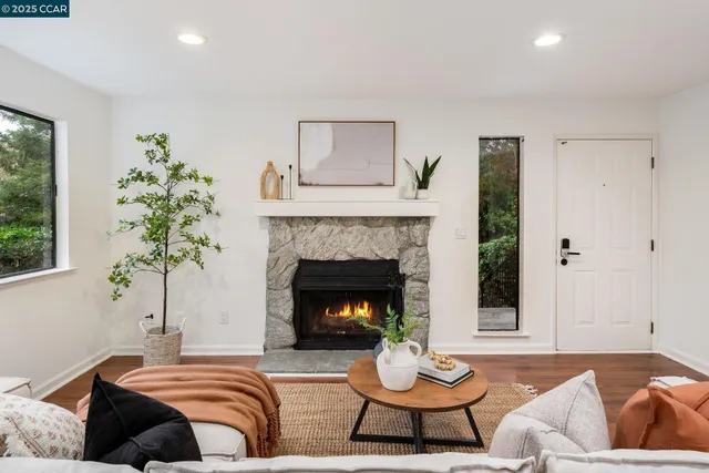 a living room with furniture and a fireplace