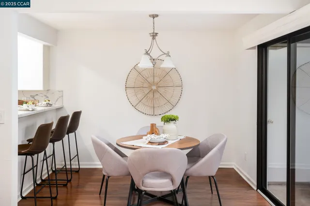 a view of a dining room with a table and chairs