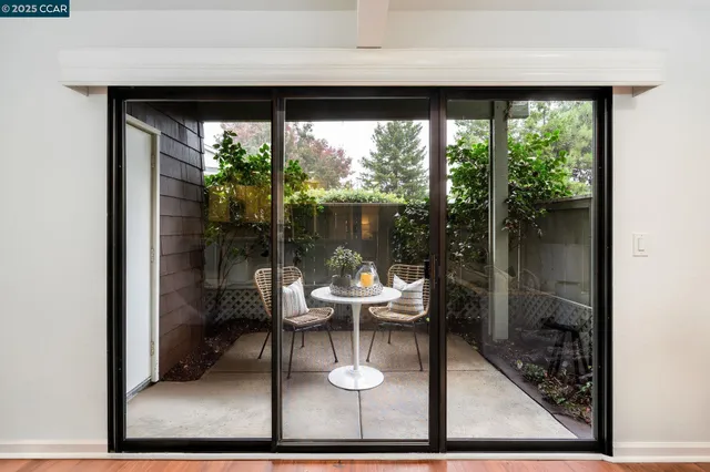 a living room with a floor to ceiling window and a floor to ceiling window