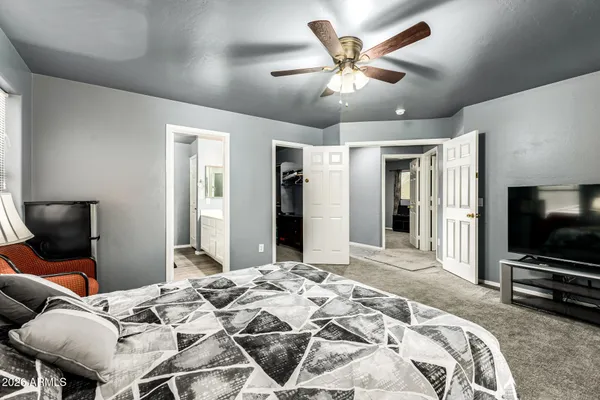 a bedroom with a bed and a flat screen tv